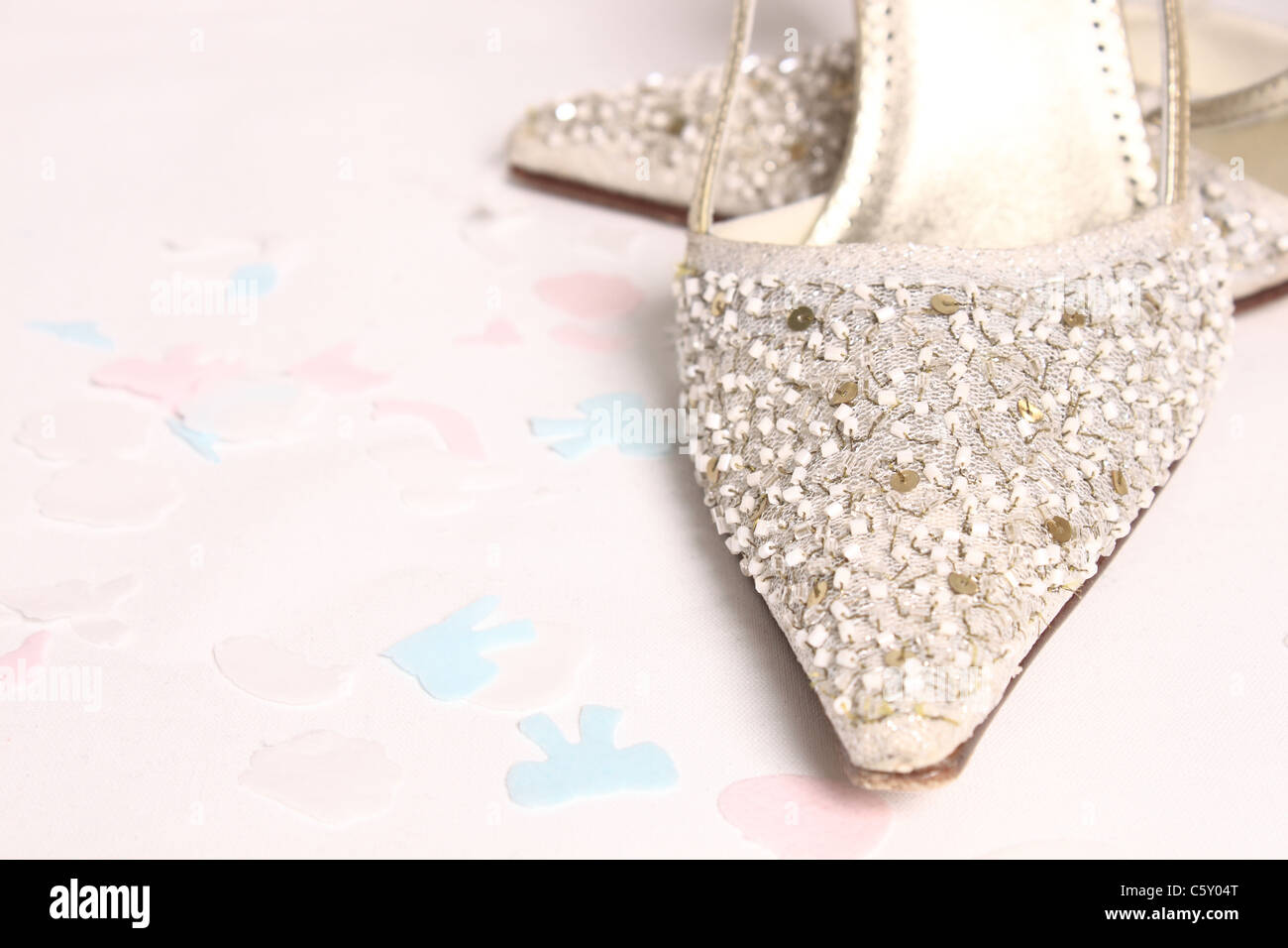 Beaded Wedding Shoes with Confetti on a white background Stock Photo