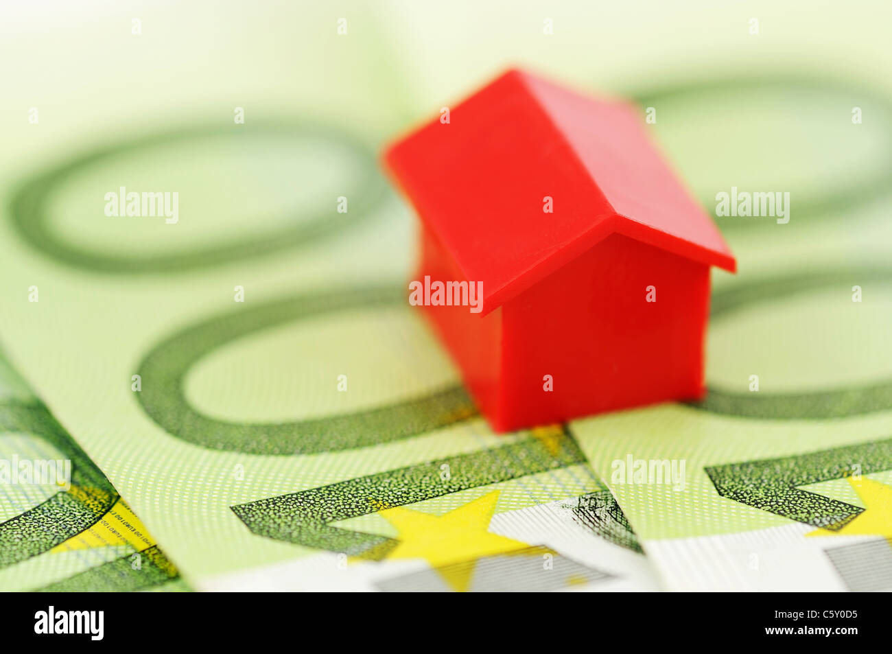 Close-up of a red model house and banknotes Stock Photo