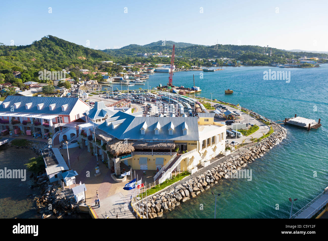 Tour buses and rental cars lined up behind Town Center shops at cruise