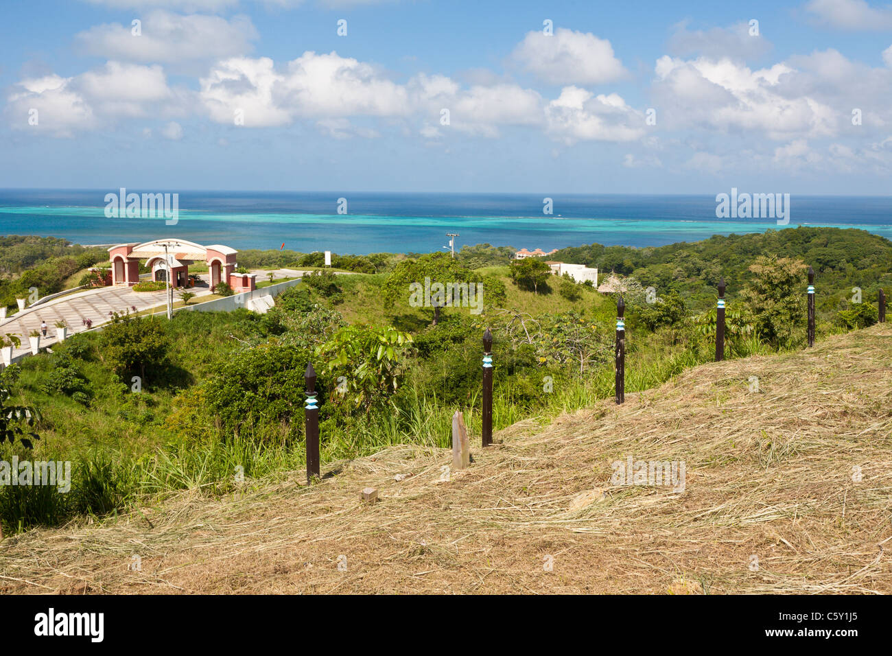 Entrance road to gated resort overlooking Caribbean Sea on the island of Roatan, in Honduras Stock Photo