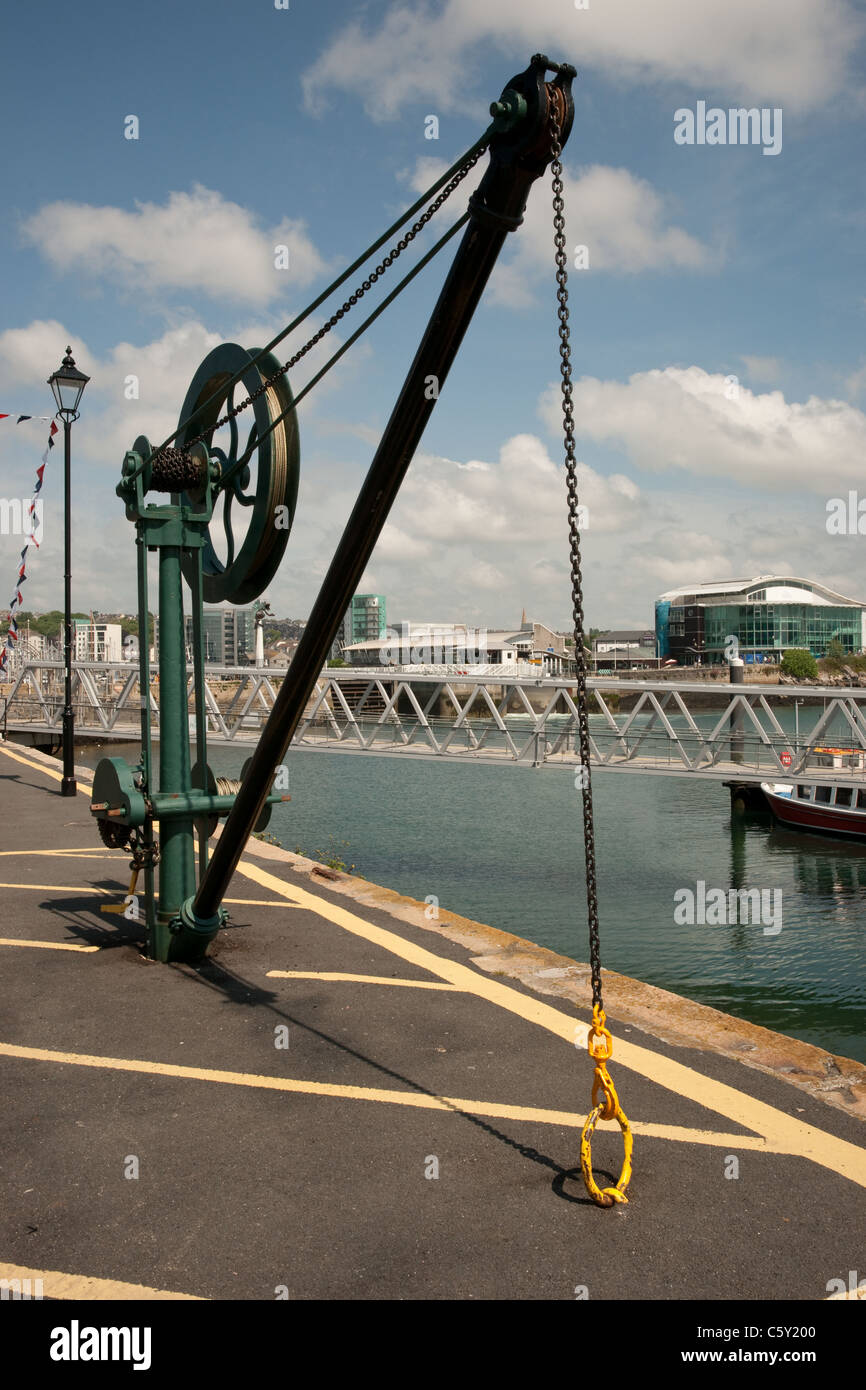 A vertical shot of a pulley crane on the quayside in Plymouth docks/marina Stock Photo