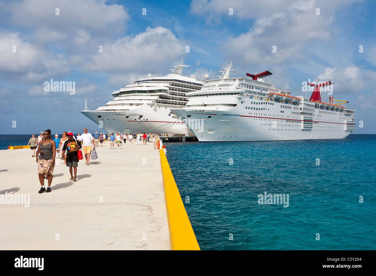 Cruise ship passengers on pier disembarking from cruise ships in Cozumel, Mexico in the Caribbean Sea Stock Photo