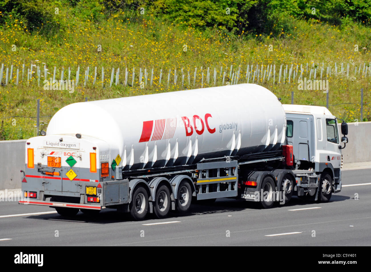 British Oxygen Company BOC liquid gas material in articulated tanker trailer and hgv lorry truck driving along motorway England UK Stock Photo