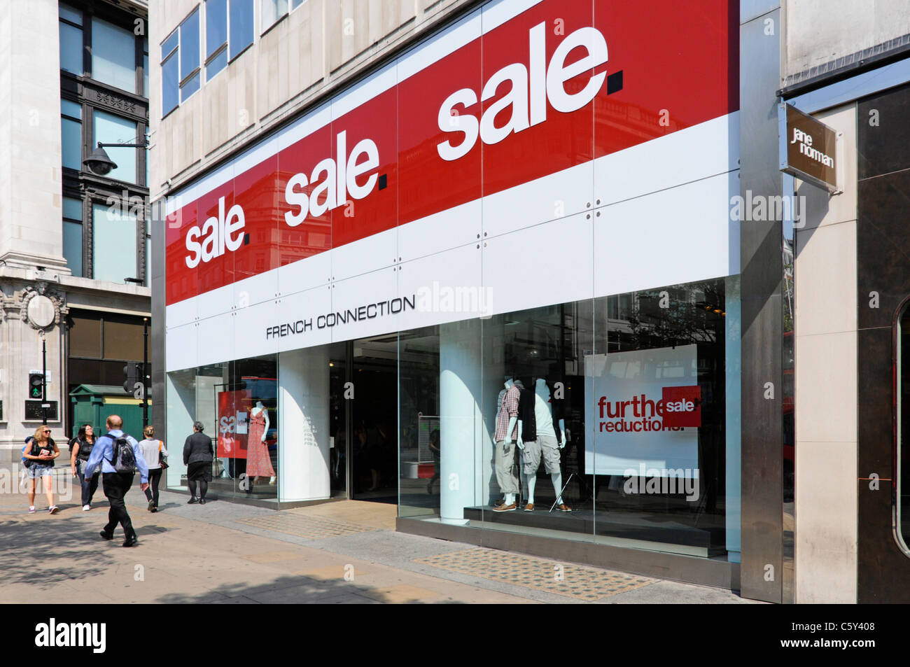 Large sale signs above entrance to French Connection retail fashion business shopping store in Oxford Street London West End England UK Stock Photo