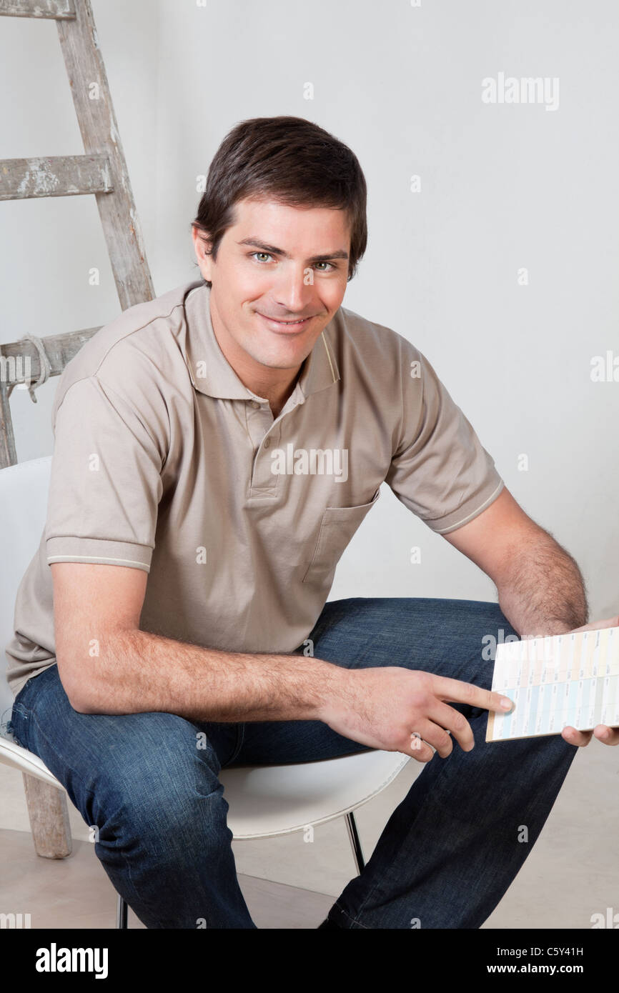 Portrait of happy mature man holding color swatch in his hand Stock ...