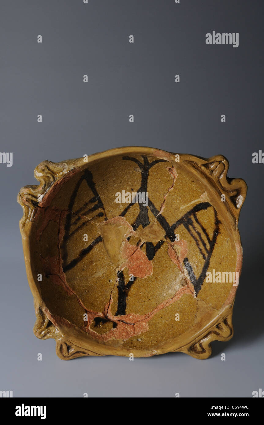 Glazed ceramic bowl decorated with Firebird . Medieval period in  " Burgo de Santiuste Museum"- SPAIN Stock Photo