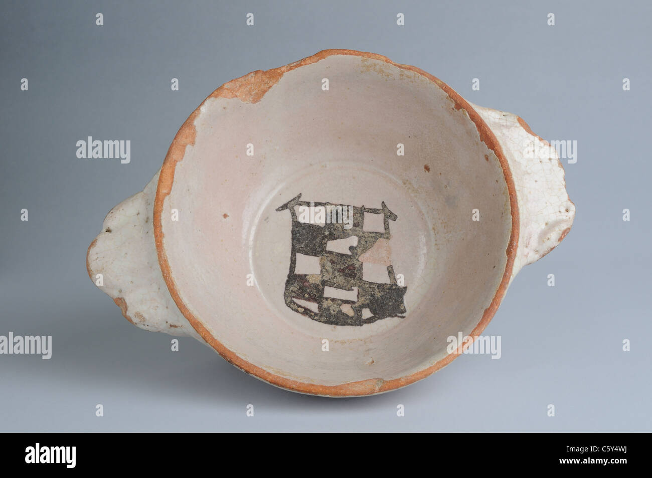 Glazed ceramic bowl with checkered heraldic shield. Modern era  in  ' Burgo de Santiuste Museum'- SPAIN Stock Photo