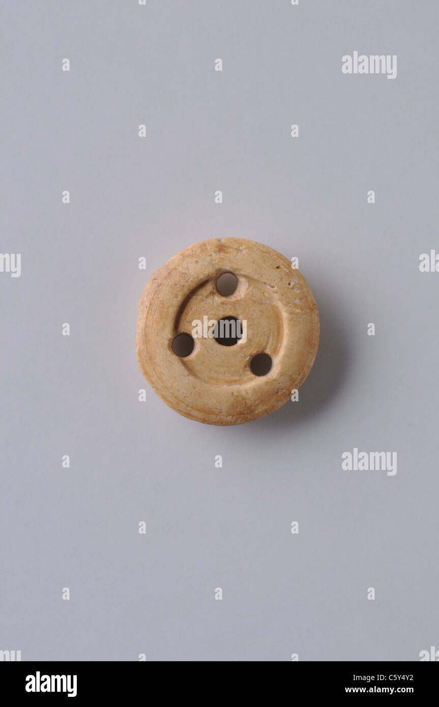 Bone Button with four holes. Medieval period in  ' Burgo de Santiuste Museum'- SPAIN Stock Photo