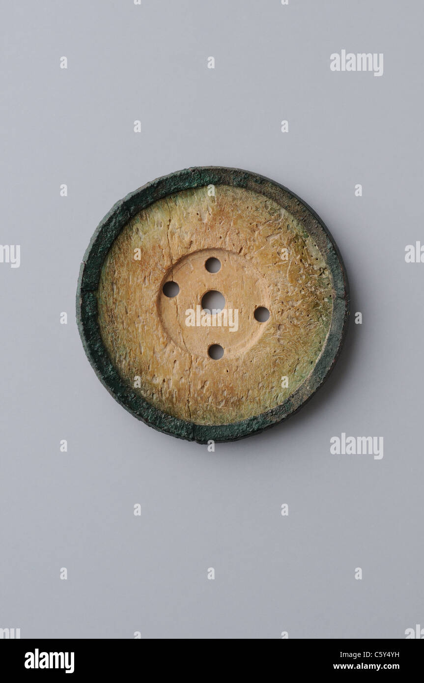 Bone Button with five holes . Medieval period in  ' Burgo de Santiuste Museum'- SPAIN Stock Photo