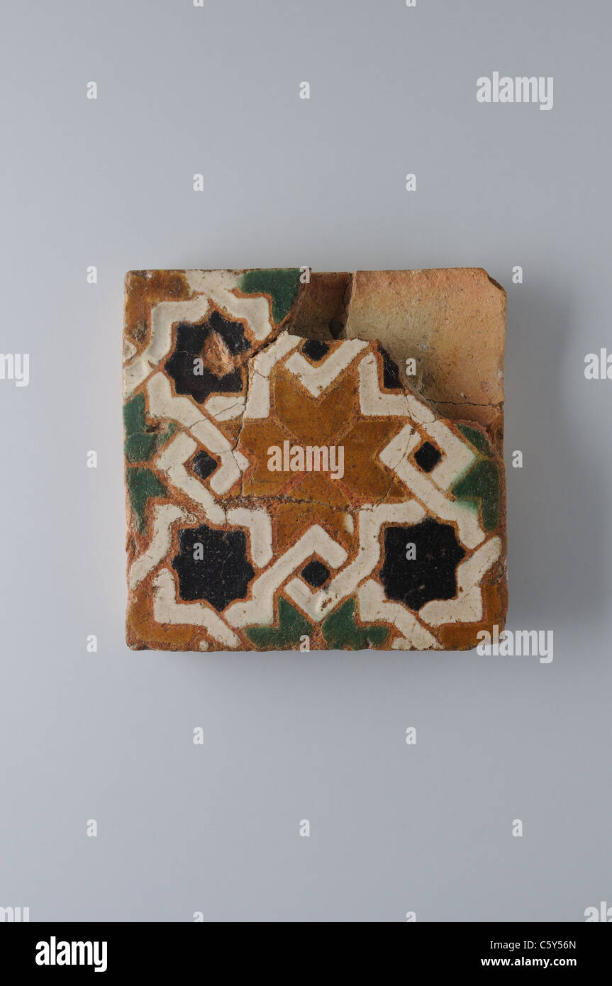 Glazed ceramic tile with geometric decoration 10 x 9, 5 cm. (15 th CE ) - Modern era in  " Burgo de Santiuste Museum"- SPAIN Stock Photo