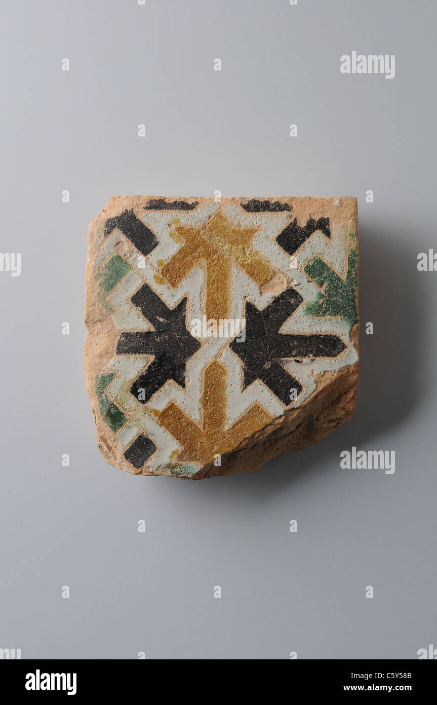 Glazed ceramic tile with geometric decoration 10 x 9, 5 cm. (15 th CE ) - Modern era in  ' Burgo de Santiuste Museum'- SPAIN Stock Photo