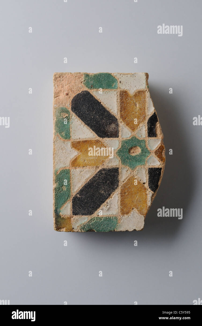 Glazed ceramic tile with geometric decoration 10 x 9, 5 cm. (15 th CE ) - Modern era in  ' Burgo de Santiuste Museum'- SPAIN Stock Photo