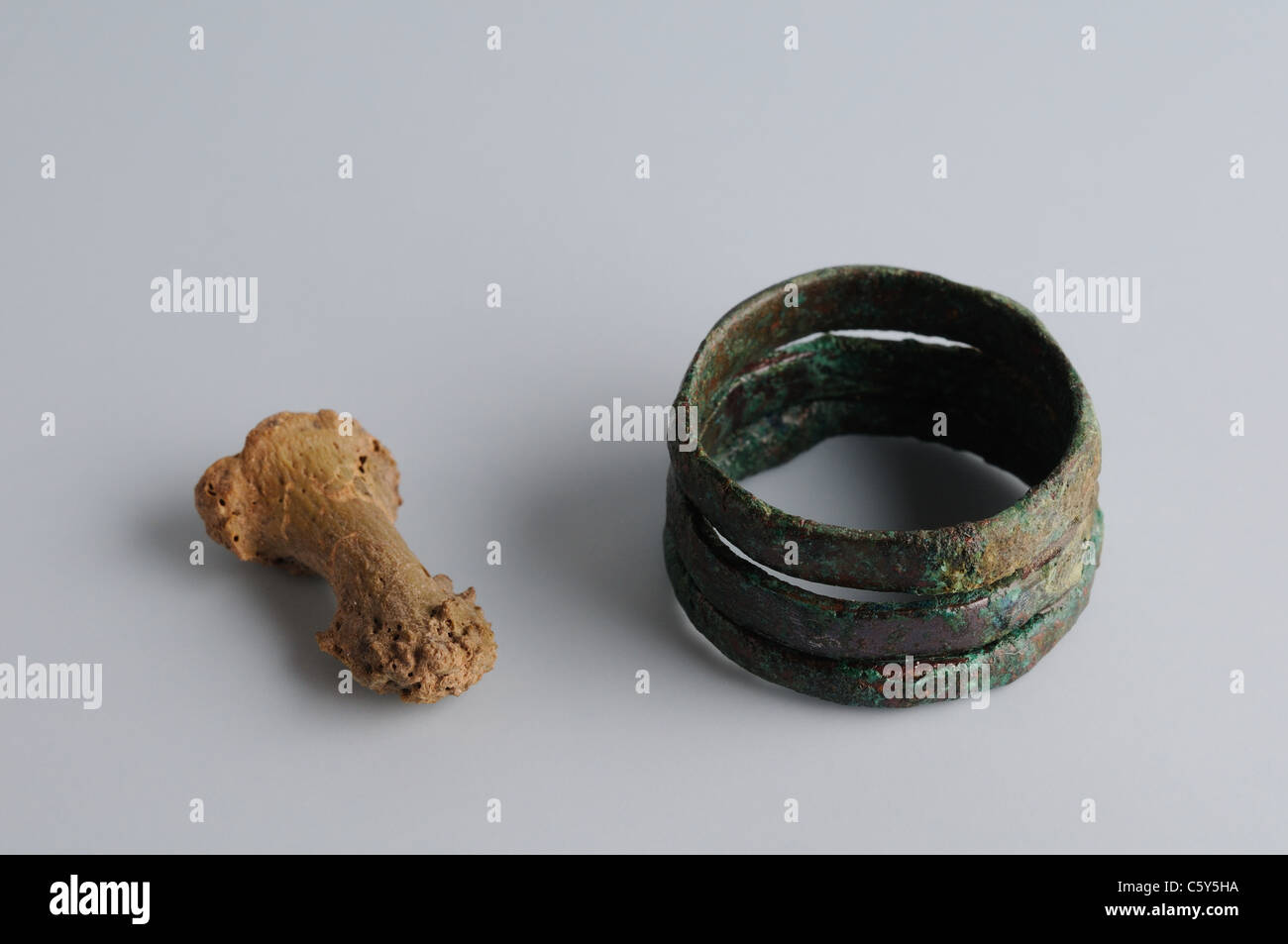 Ring of three soldiers copper rings associated with small phalanx bone. Medieval period  in  ' Burgo de Santiuste Museum'- SPAIN Stock Photo