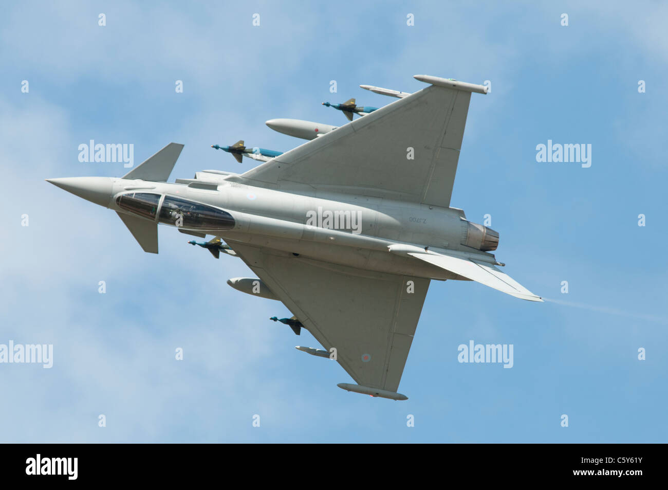 British military fighter aircraft Eurofighter Typhoon number ZJ700 rolls while displaying fully loaded at the 2011 Air Tattoo Stock Photo
