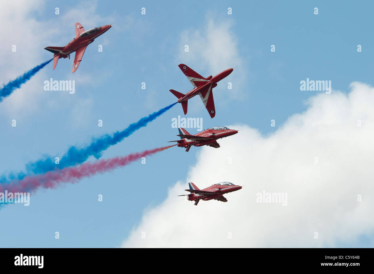 British military aerobatic display team The Red Arrows perform a formation break at the 2011 Royal International Air Tattoo RAF Stock Photo