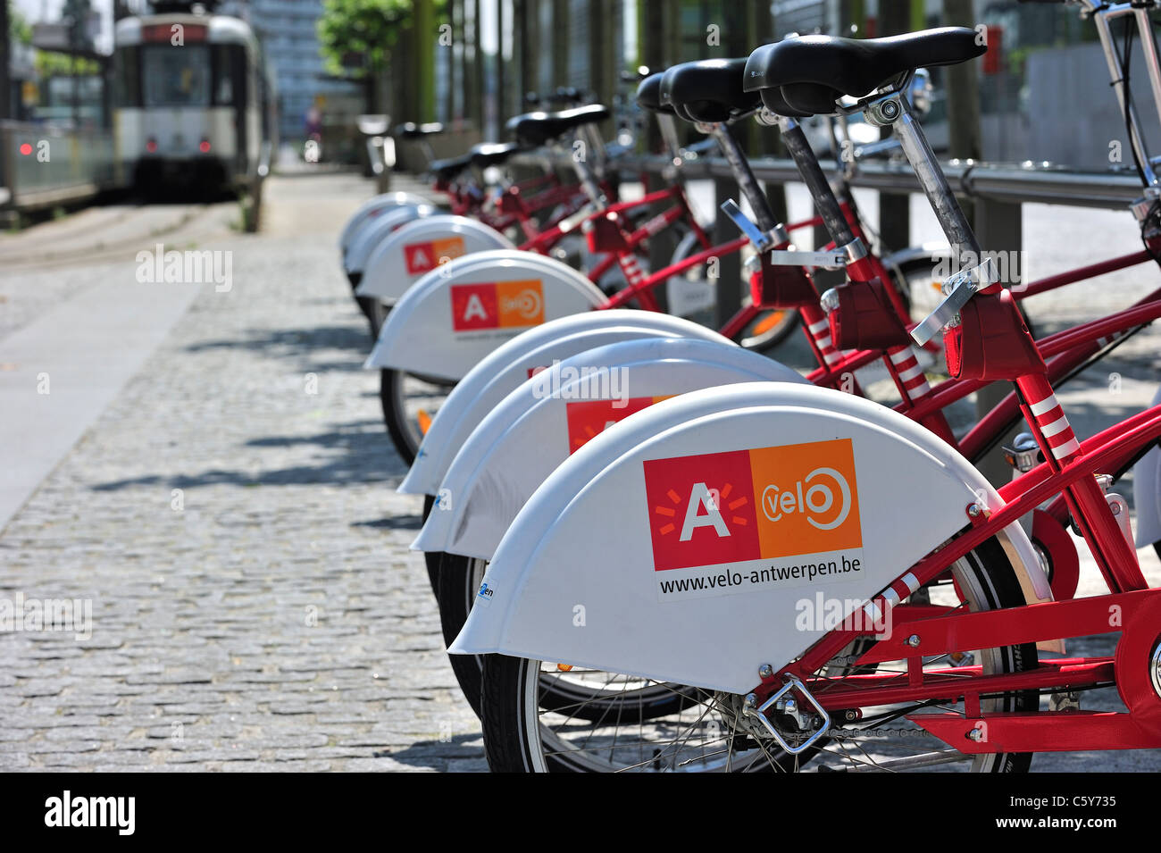 Parked red bicycles in one of the Velo stations at Antwerp, Belgium Stock Photo