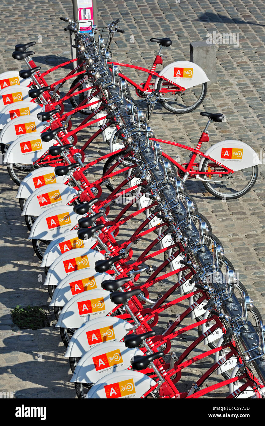 Parked red bicycles in one of the Velo stations at Antwerp city, Belgium Stock Photo