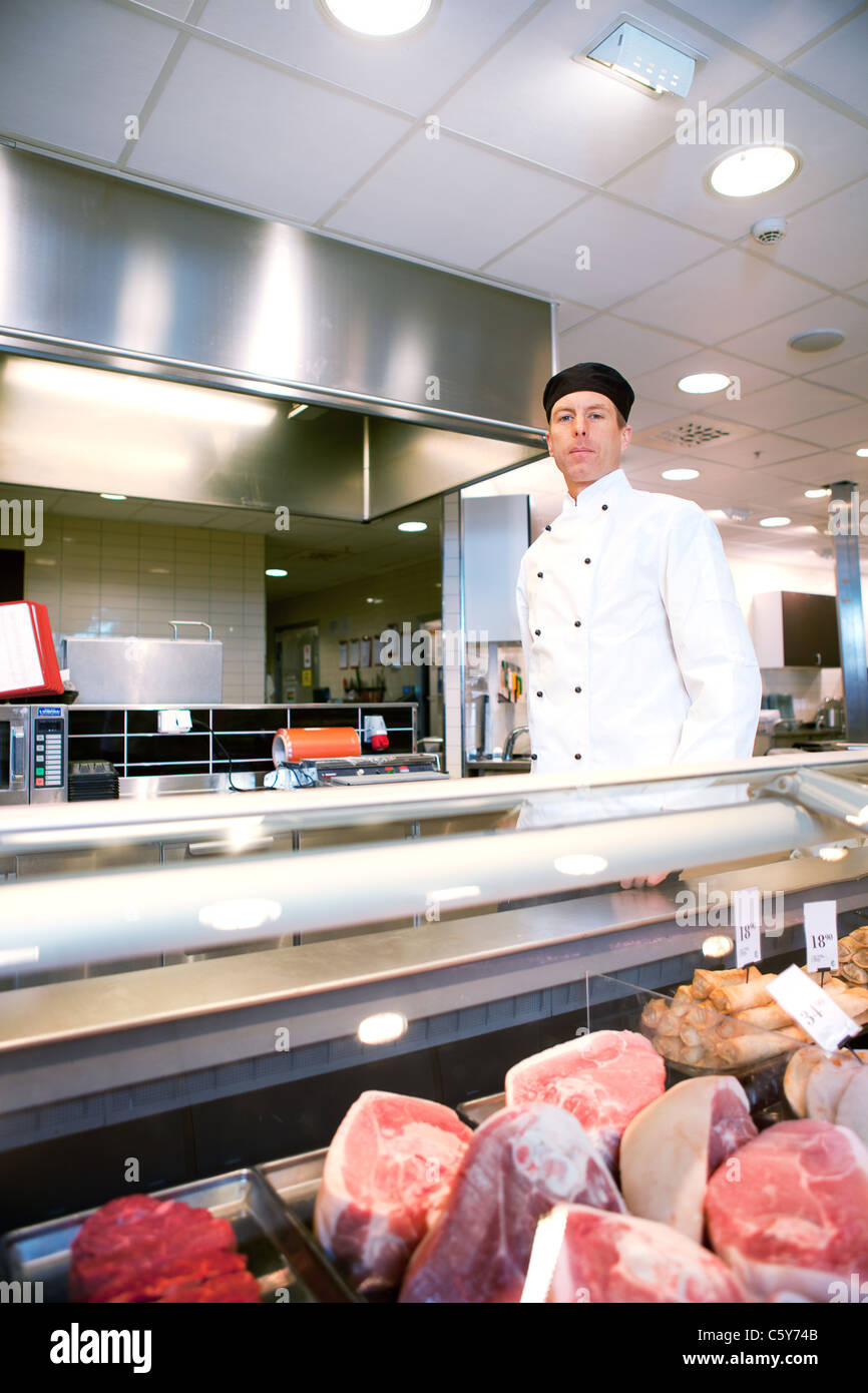 Supermarket meat counter service staff hires stock photography and