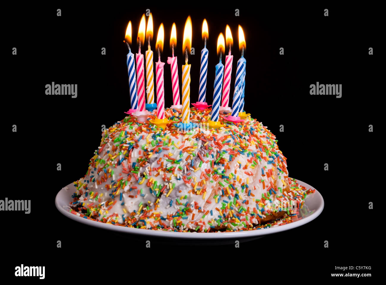 a cake with many coloured candles before black background Stock Photo ...