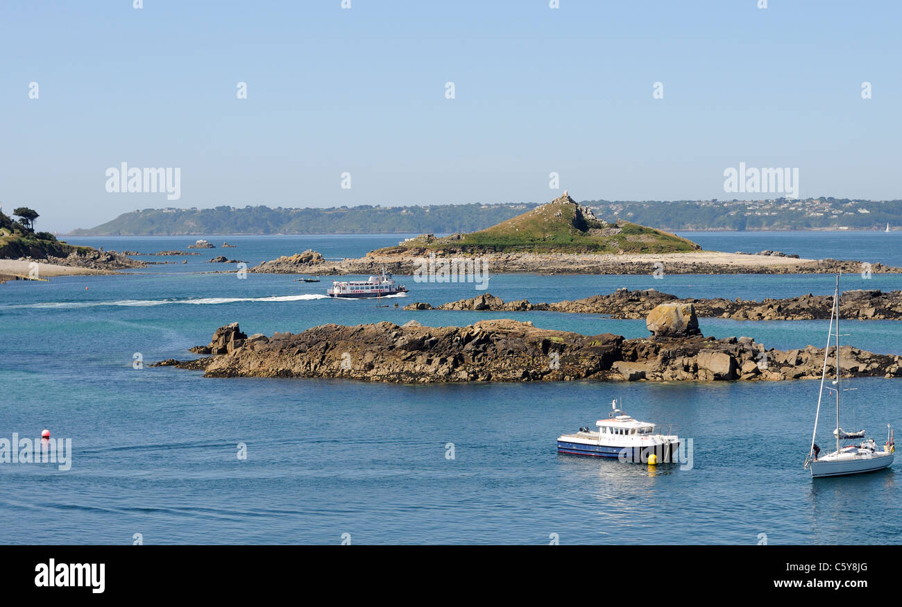 A Trident ferry leaves Herm for St Peter Port in Guernsey. Crevichon Island,  Jehu and Guernsey can be seen in the background. Stock Photo