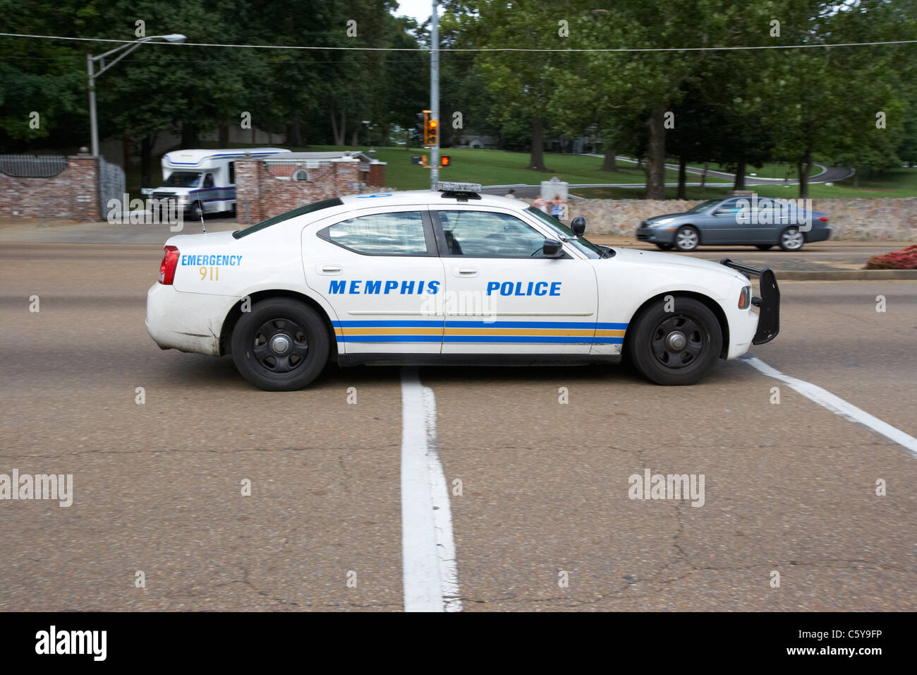 memphis police patrol car speeds down elvis presley boulevard outside