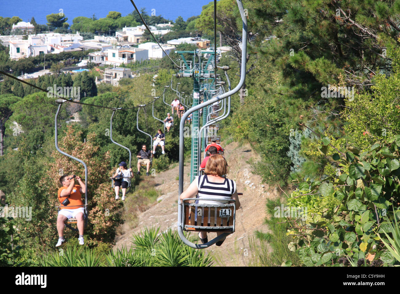 A Woman Rides A Chair Lift On Capri In Italy Stock Photo Alamy