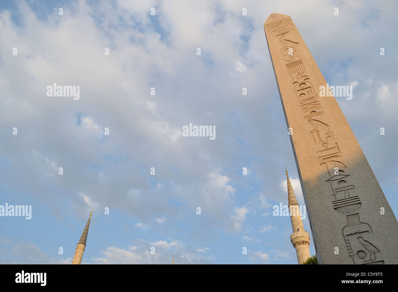 Two of the Blue Mosque's minarets behind a pillar at the Hippodrome, Istanbul, Turkey, July 2011 Stock Photo