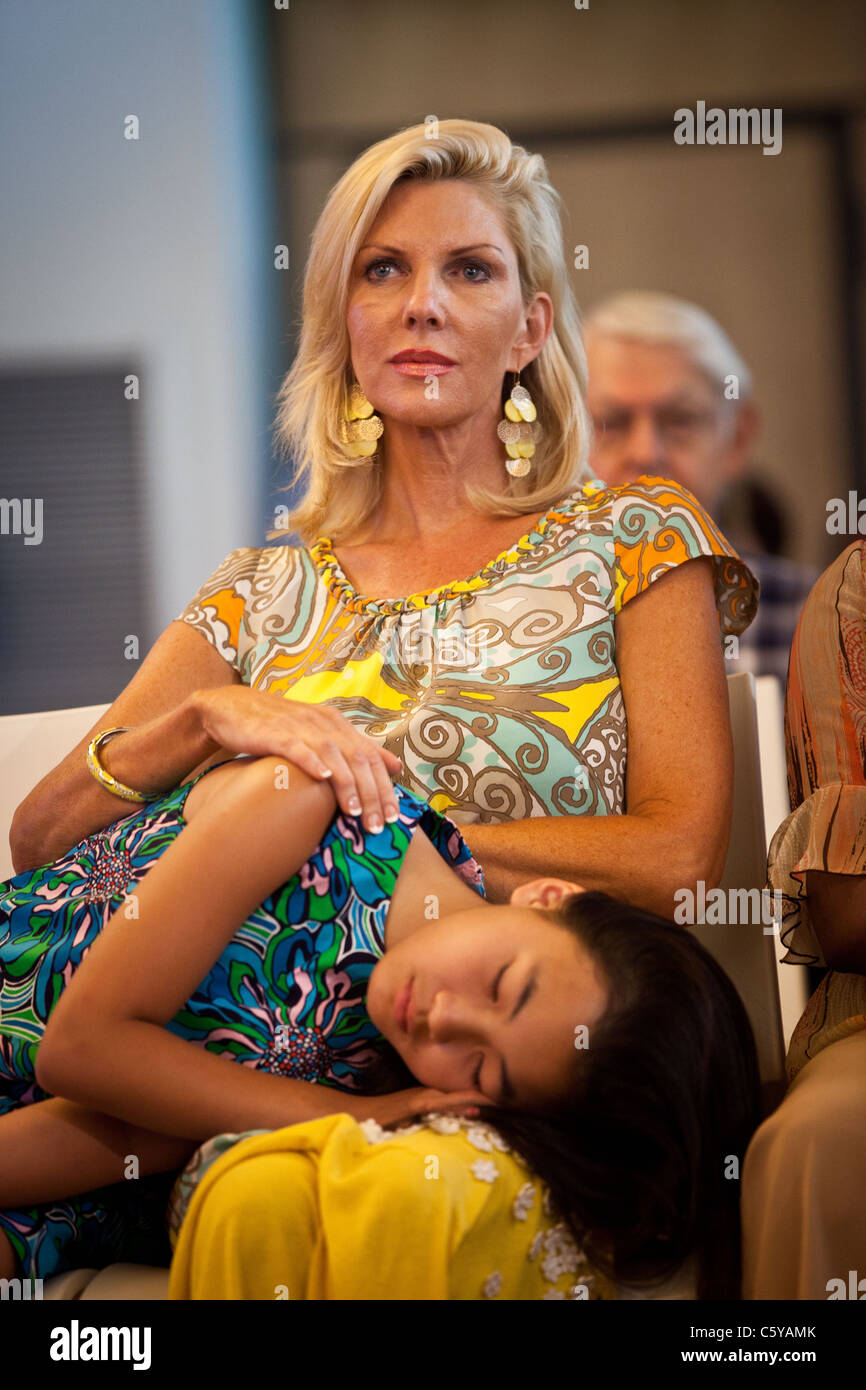 Gracie Mei, adopted daughter of GOP Presidential candidate Jon Huntsman sleeps on the lap of her mother Mary Kaye Huntsman Stock Photo