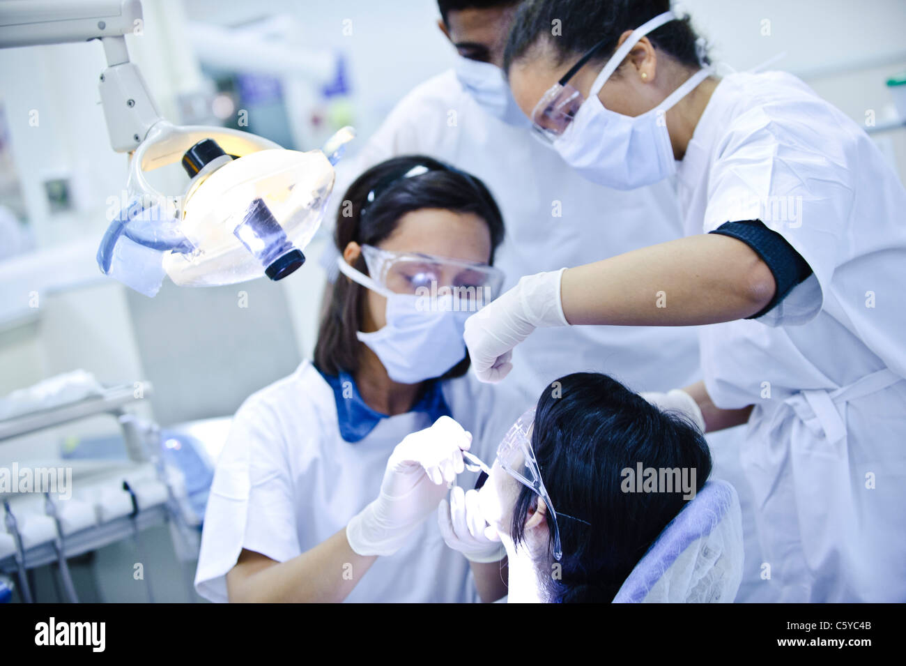 Dentistry students wearing white surgical masks goggles and tunics in