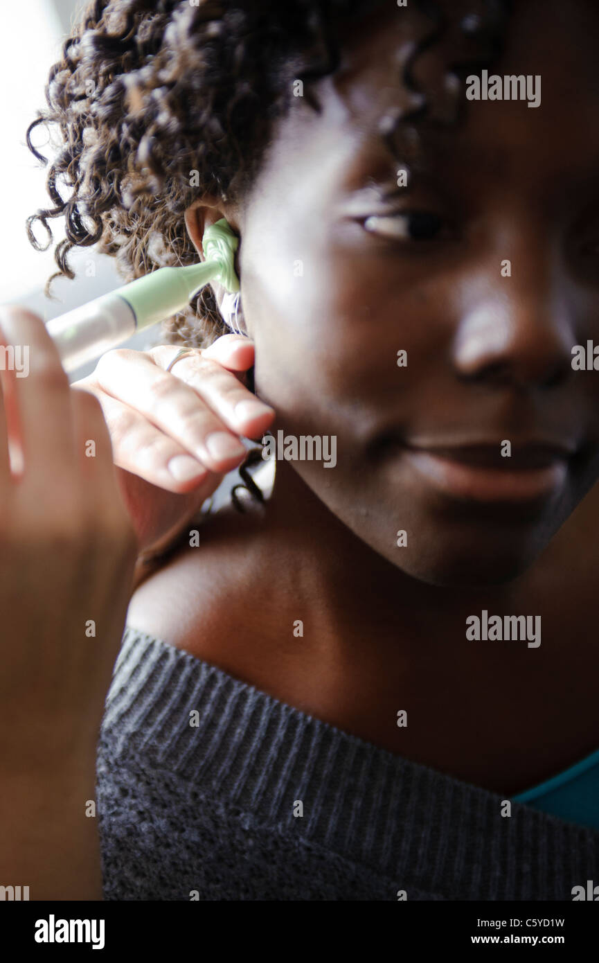 Audiology and deafness student syringing green compound into ear canal