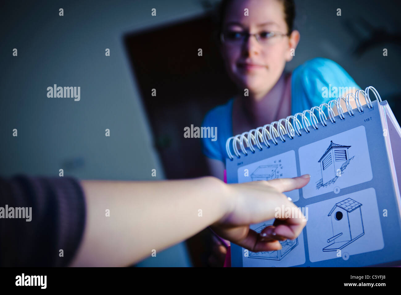 Female speech and language therapist in training session with picture cards blue Stock Photo