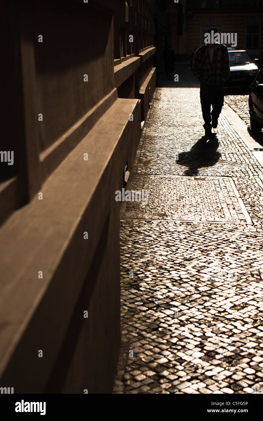 silhouette and shadow of a man walking on a street in prague Stock ...