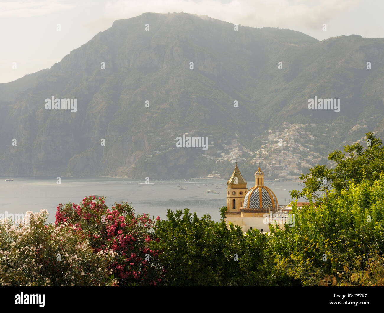 Praiano basilica San Gennaro with Positano in background, Amalfi Coast Stock Photo