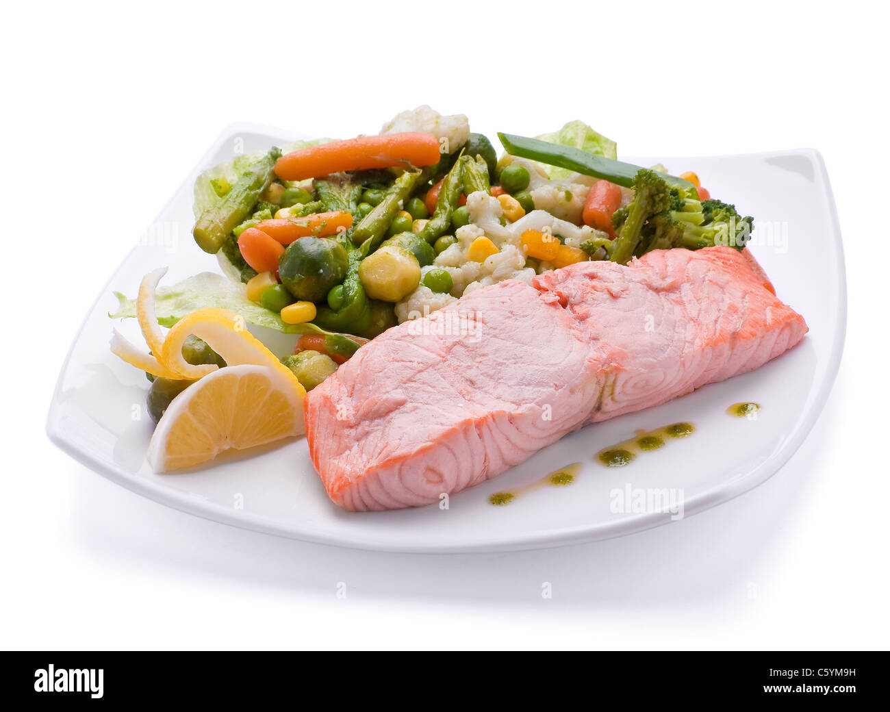 Red fish with boiled vegetable on white plate Stock Photo