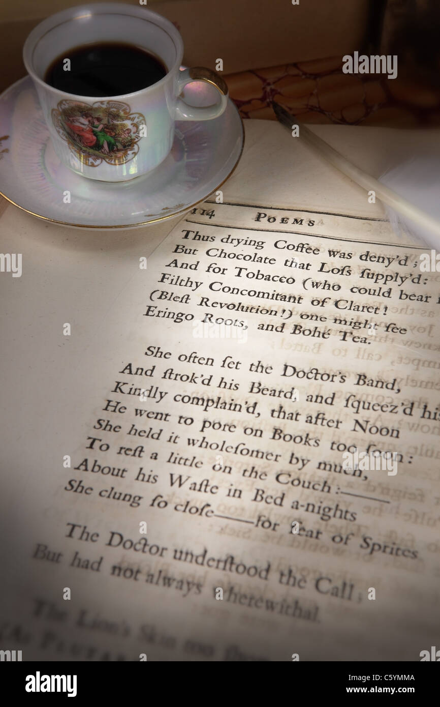 cup, saucer, quill resting on a poetry page written in Old English (Poems  On Several Occasions printed in 1718, first edition Stock Photo - Alamy