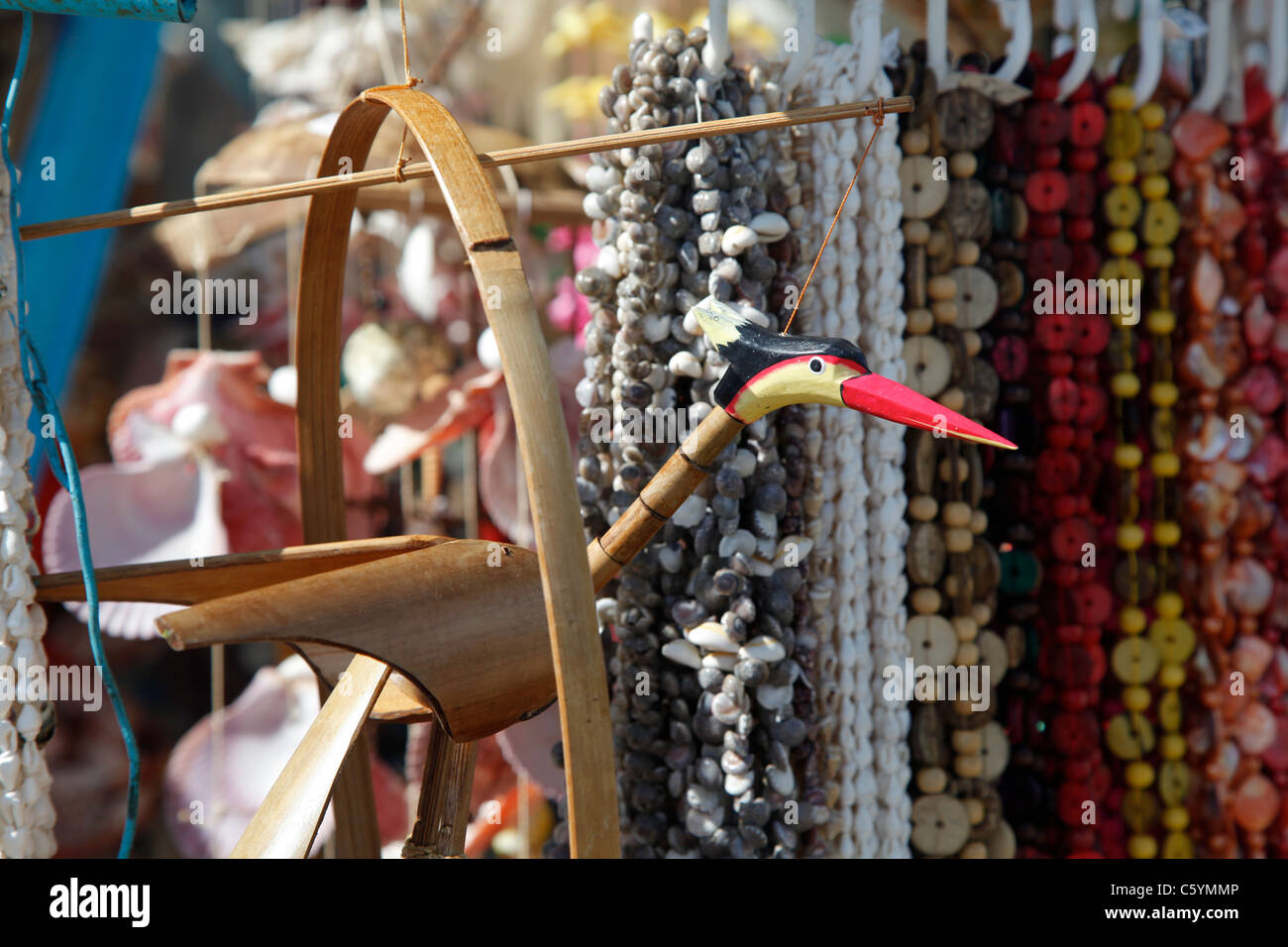 Some handcrafted souvenirs at a stand with a crane bird shaped decoration in the foreground Stock Photo