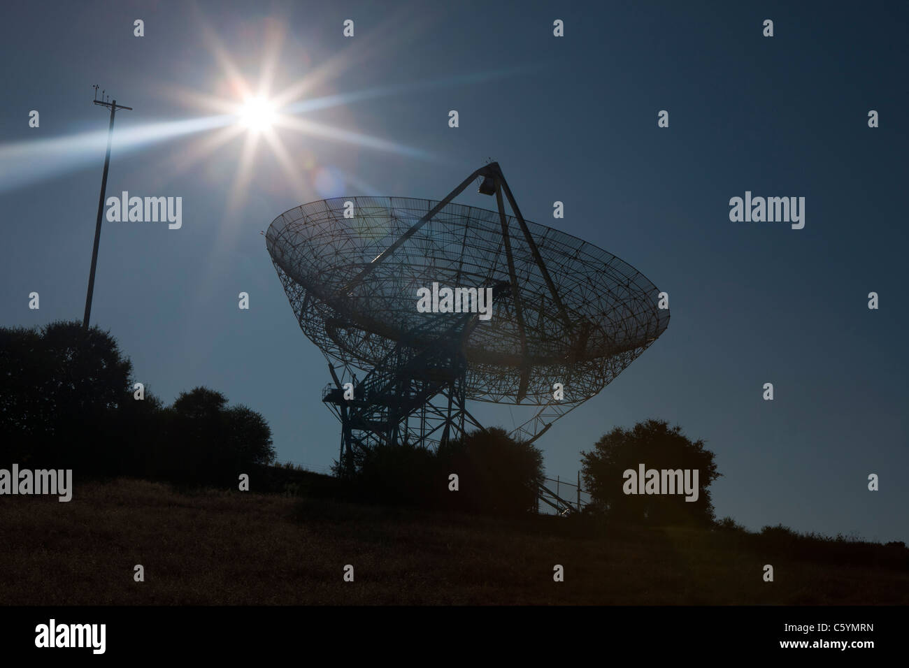 The sun sets behind The Stanford Dish, an active radio telescope, Stanford, California, United States of America Stock Photo