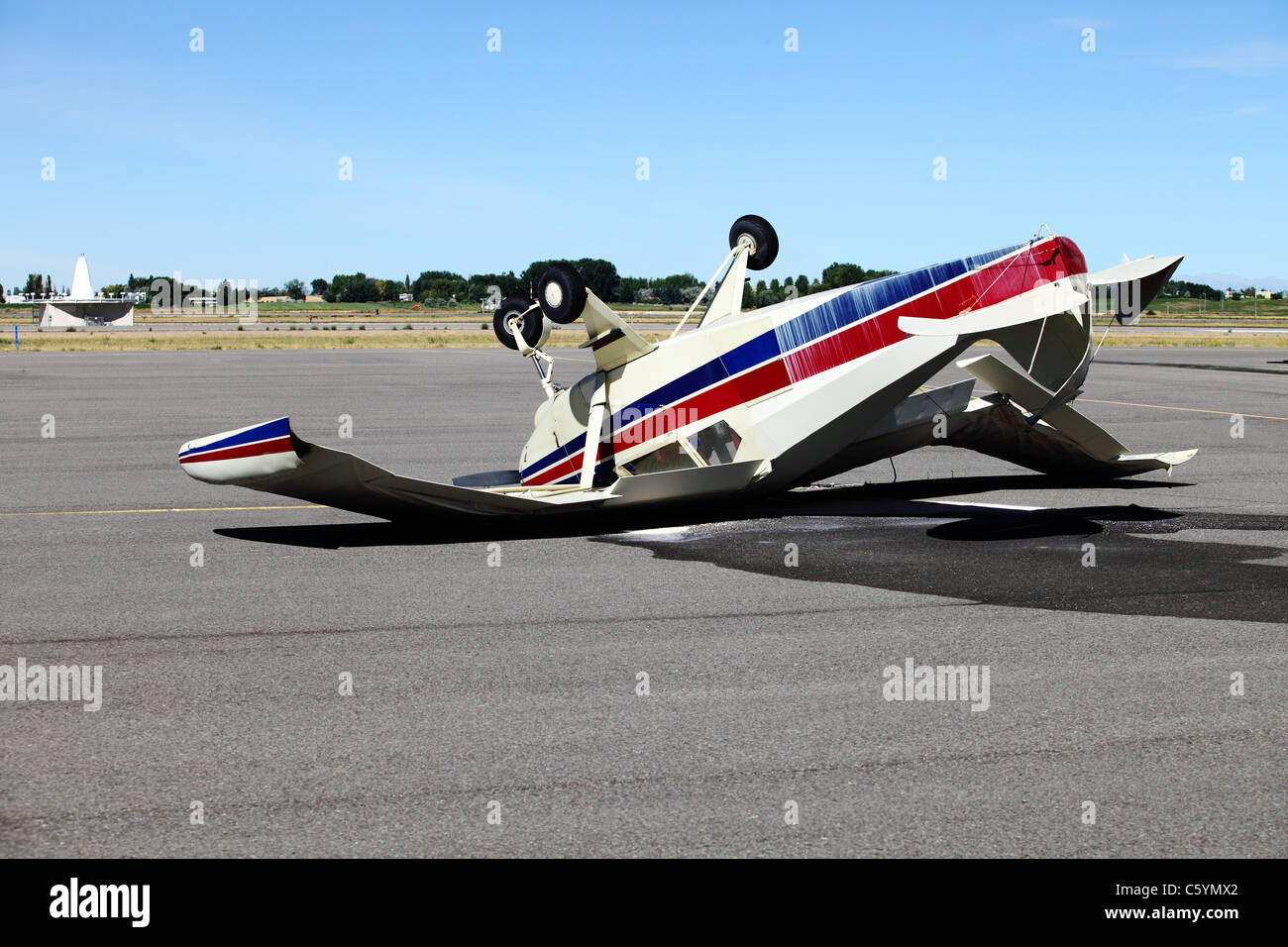 An mangled airplane resting upside down on the tarmac Stock Photo - Alamy