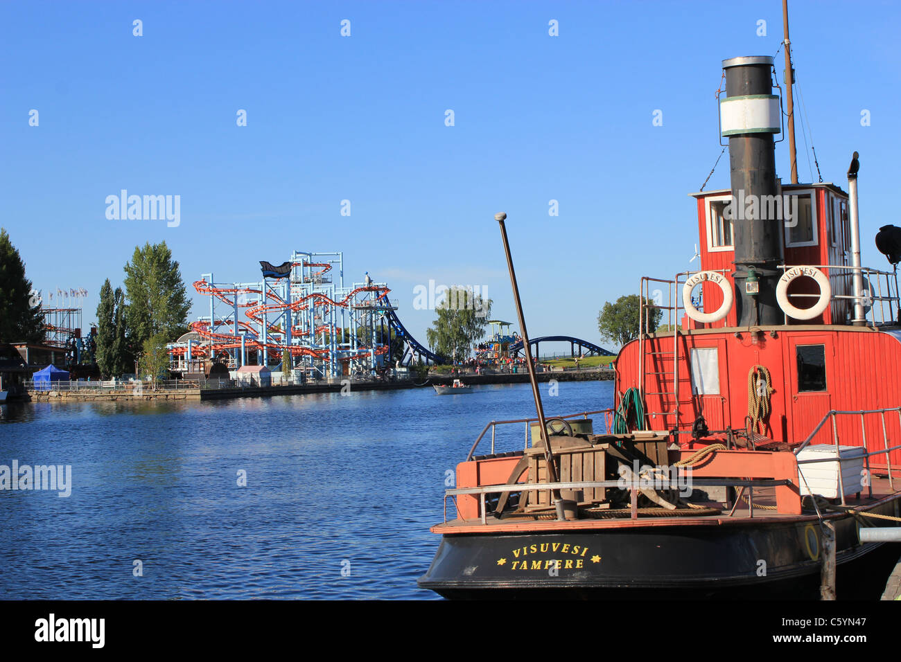 Old boat and view of the amusement park Särkänniemi that is seen from Mustalahti, Tampere Stock Photo