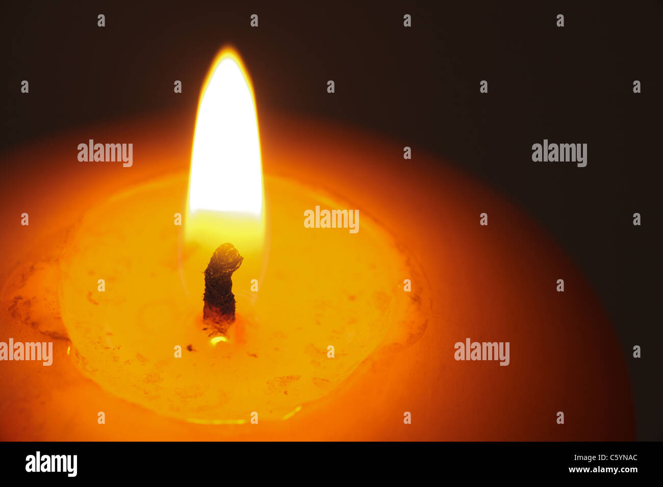 Closeup of burning candle isolated on black background Stock Photo - Alamy
