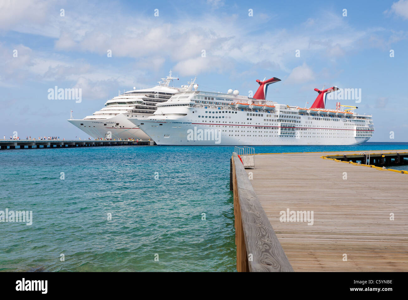 Cruise ship passengers on pier disembarking from Carnival cruise ships ...