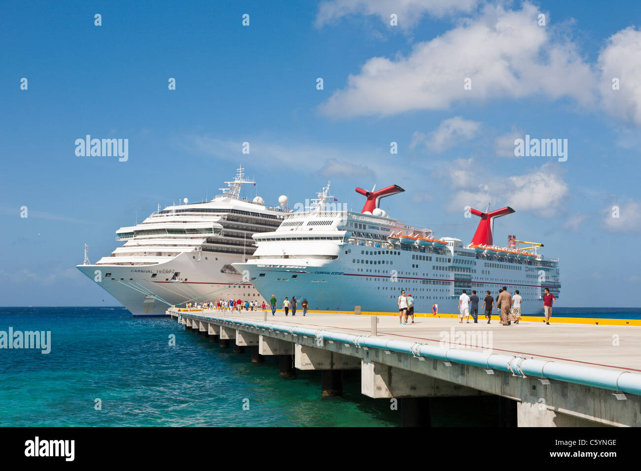 Cruise ship passengers on pier disembarking from Carnival cruise ships ...
