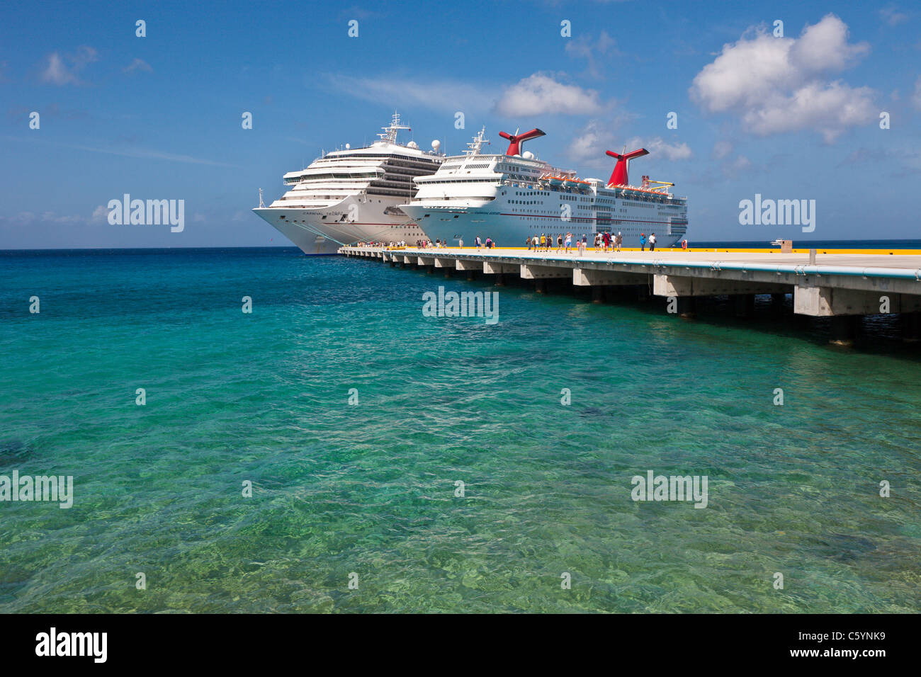 Cruise ship passengers on pier disembarking from Carnival cruise ships ...