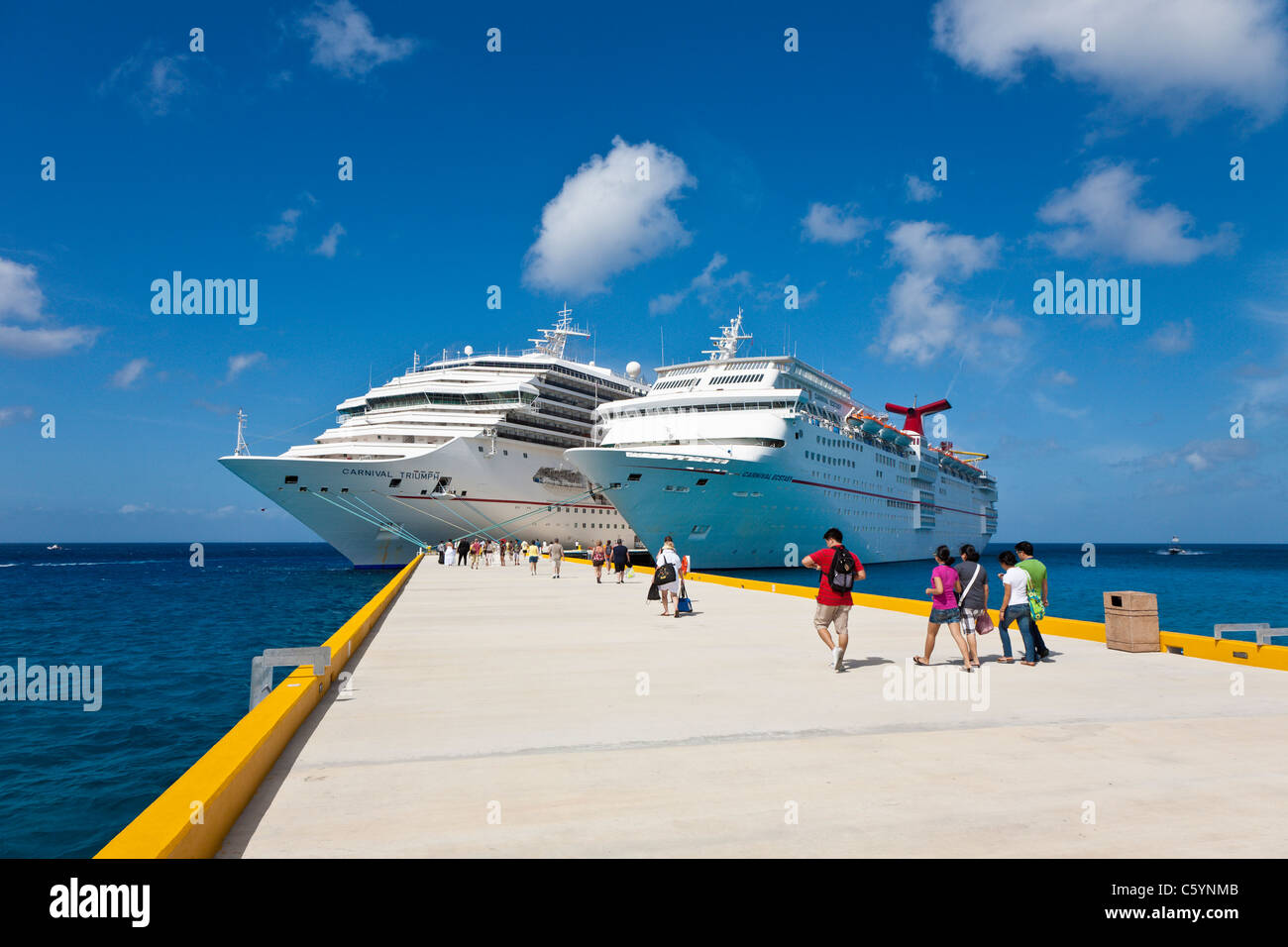 Cruise ship passengers on pier disembarking from Carnival cruise ships ...