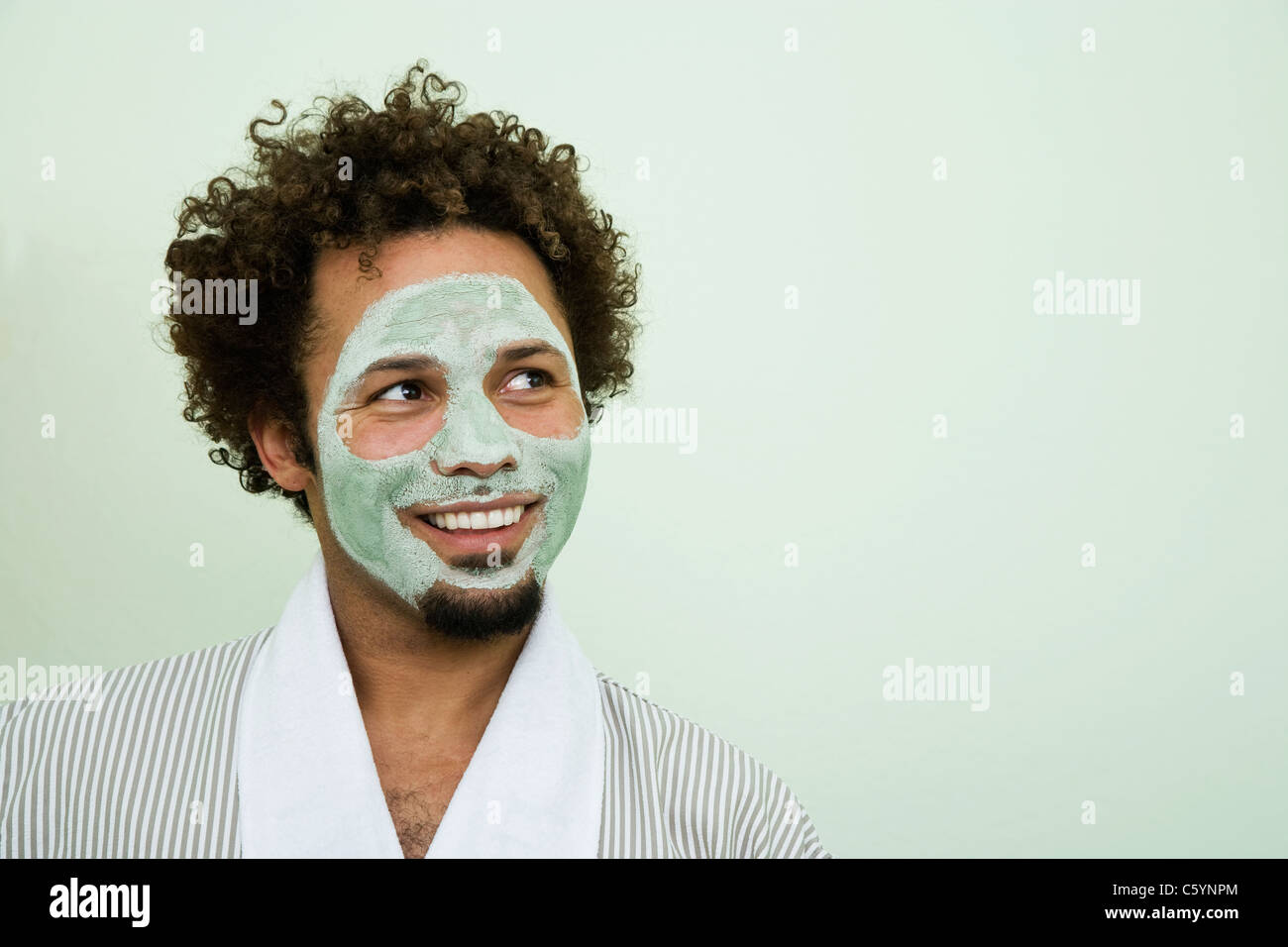 USA, California, Oakland, portrait of smiling man with facial mask Stock Photo