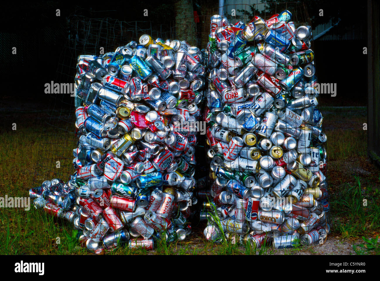 Used aluminum soda pop and beer cans being collected for recycling fill up two wire mesh bins outdoors at a campground in Florida, USA. Stock Photo