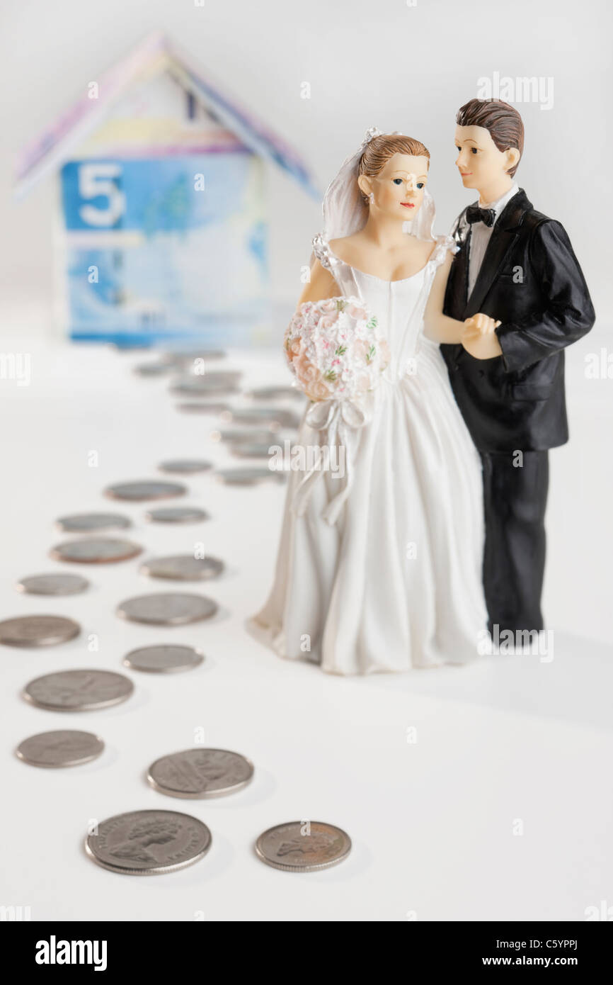 Bride and groom on money path near banknote house Stock Photo Alamy