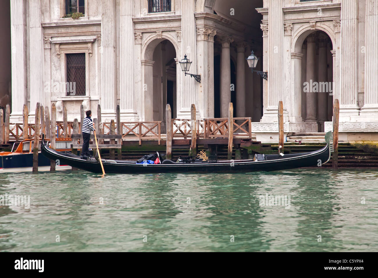 Gondola sailing in Venice channel Stock Photo - Alamy