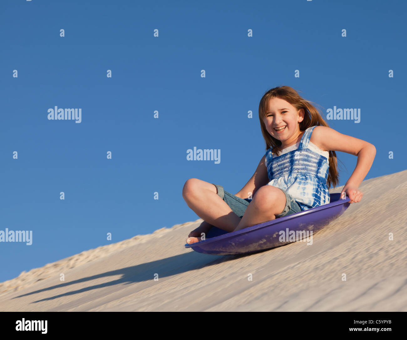 USA, New Mexico, Whitesands, Girl (1011) sliding down sand dune Stock Photo Alamy
