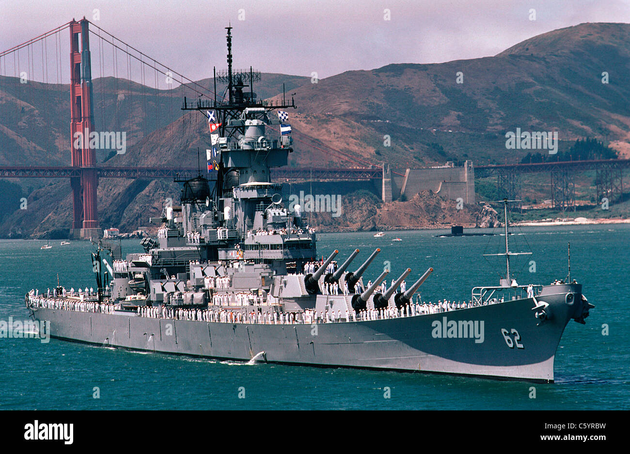 USS New Jersey steams past the Golden Gate Bridge in San Francisco Bay, California. Stock Photo